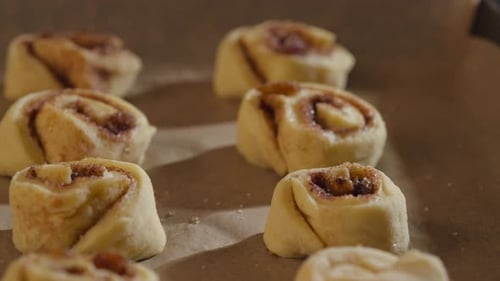 Cinnamon Rolls Ready For Baking Arrange In The Pan. - closeup slider shot