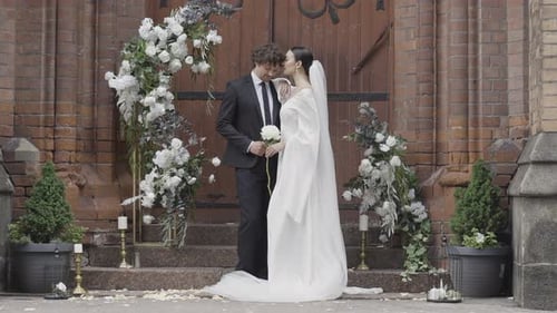 Young beautiful elegant couples stand happy and shoot videos in the street