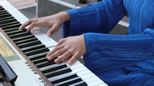 Young Woman Plays on a Digital Piano Outdoor Mini Concert on City Market Woman Wearing Electric Blue
