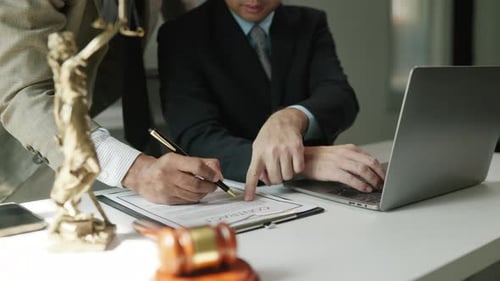Lawyers Working on Contract in Office