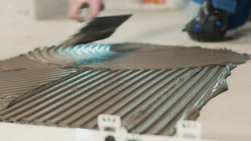 Applying Cement With Grooved Trowel For Home Renovation