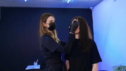 Woman Receiving Eyebrow Makeup at Beauty Salon