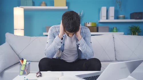 Frustrated young man thoughtful at home.