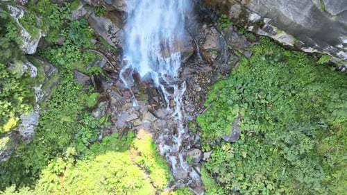 Aerial View of Waterfall Flowing Over Rocks
