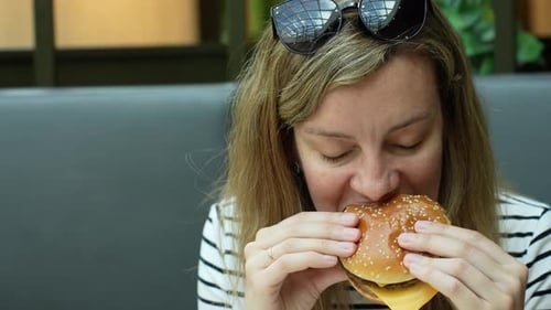 Woman Eating Burger Close Up Portrait