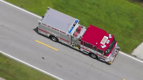 Medical Personnel Treat Resident at Home As Emergency Vehicles Block Quiet Suburban Street