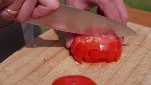 Dicing a Fresh Tomato on Wooden Board