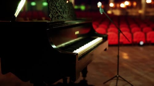 Elegant Grand Piano with Red Theater Seats in Classic Opera House Setting