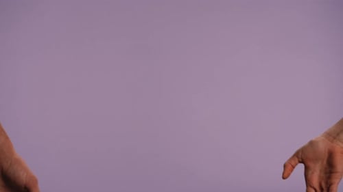 Man and Woman Hands Showing Gestures and Making Heart Love Hand Sign Isolated on Purple Studio