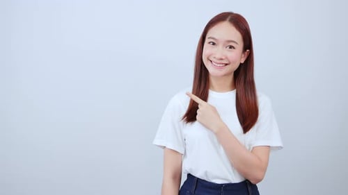 Smiling Woman Points to Blank Space, Copy Space