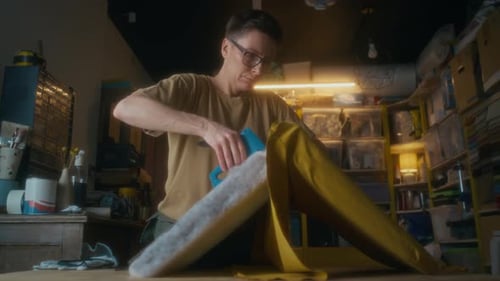 Woman Upholstering Furniture with Staple Gun in Workshop