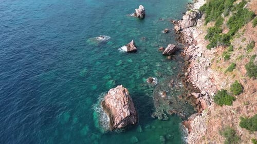 Aerial View of Picturesque Red Rocks on the Sea Coast Washed By Crystal Clear Turquoise Water