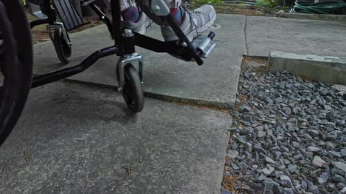 A Woman with a Disability Using a Wheelchair Encounters an Obstacle on the Road Highlighting the