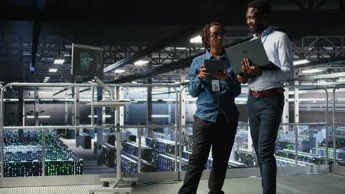 Data Center Coworkers Doing Maintenance Tasks on Laptop