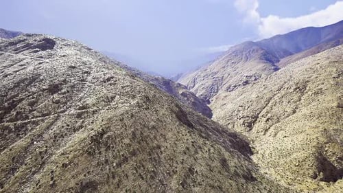 Majestic Sunlit Valley Between Rugged Ridges Ideal for Hiking Excursions