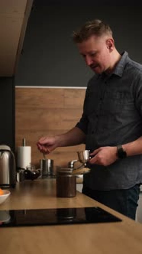 Man Preparing Coffee at Home in Kitchen