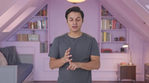 Young Adult Man Explaining Something to the Camera