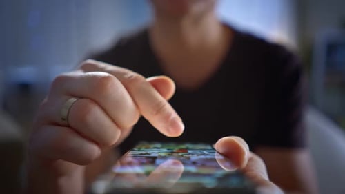 A Closeup of Male Hands Interacting with a Smartphone