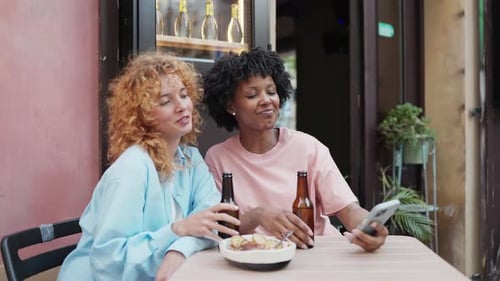 Multiethnic Friends Enjoying Drinks and Taking Selfies at Outdoor Cafe