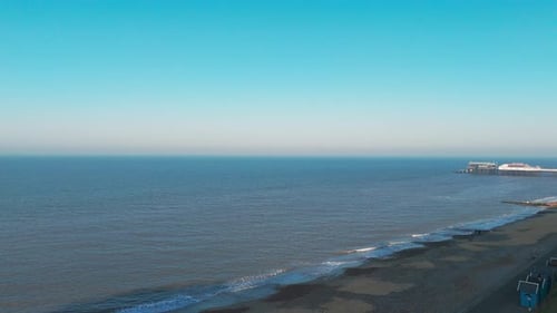Aerial view of Cromer Pier in Norfolk extending into the ocean under a clear sky