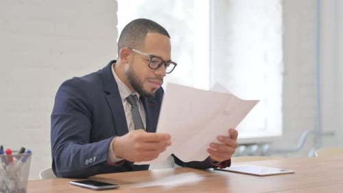 Successful Businessman Reviews Documents and Celebrates