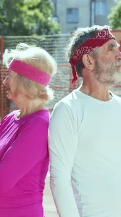 Active Senior Couple Smiling on Basketball Court