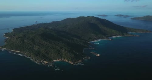 Slow drone footage flying over the island of La Digue in the Seychelles. Capturing the entire island