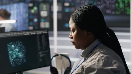 Data Center System Administrator Using PC to Monitor Neural Networks