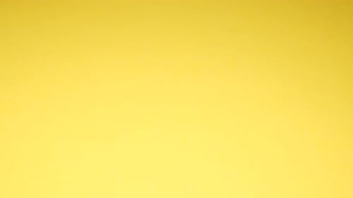 Pistachio Nuts Fall on a Yellow Background They are Rich in Vitamins A B1 B2 B3 E and K