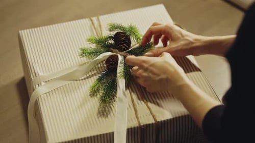 Christmas Present DIY Wrapping With Pine Cones And Sprigs. - closeup shott