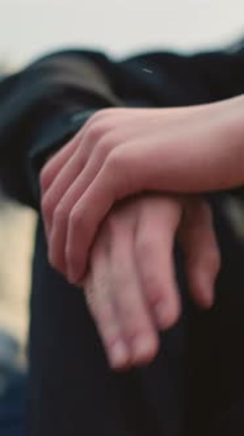 Gentle Movement of Clasped Hands with Blurred Background