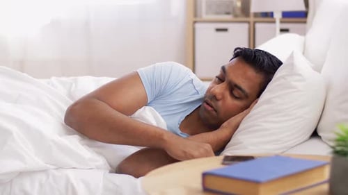 Indian Man Sleeping and Turning in Bed