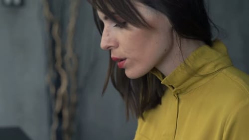 Young entrepreneur works on her laptop at a modern table in her home office