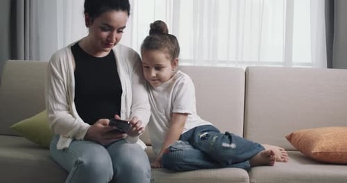 Mother and Child Looking at Phone Together