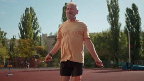 Old Caucasian Man Jumping Rope Athlete Smiling Stadium City Outside Sport Physical Activity Elderly