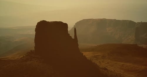 Majestic Rock Formations Under Soft Sunlight in a Serene Landscape