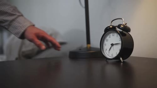 Reaching for Alarm Clock