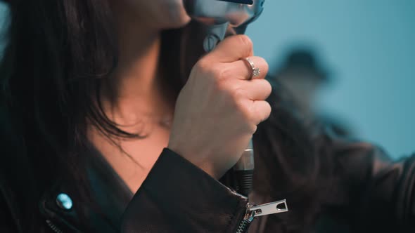 CloseUp of Faceless Singer in Leather Jacket Holding Vintage Microphone ...