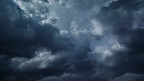 Stormy Clouds Billowing in the Dark Blue Sky