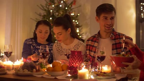 Friends and family enjoying christmas dinner together indoors