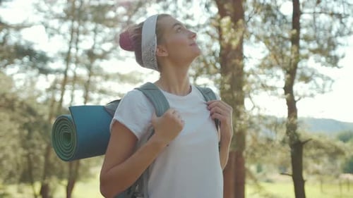 Woman Tourist with Backpack Walking in the Fall Forest on Sunny Summer Day Smile Look Around