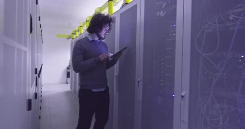 Technician Using Tablet in Modern Data Center