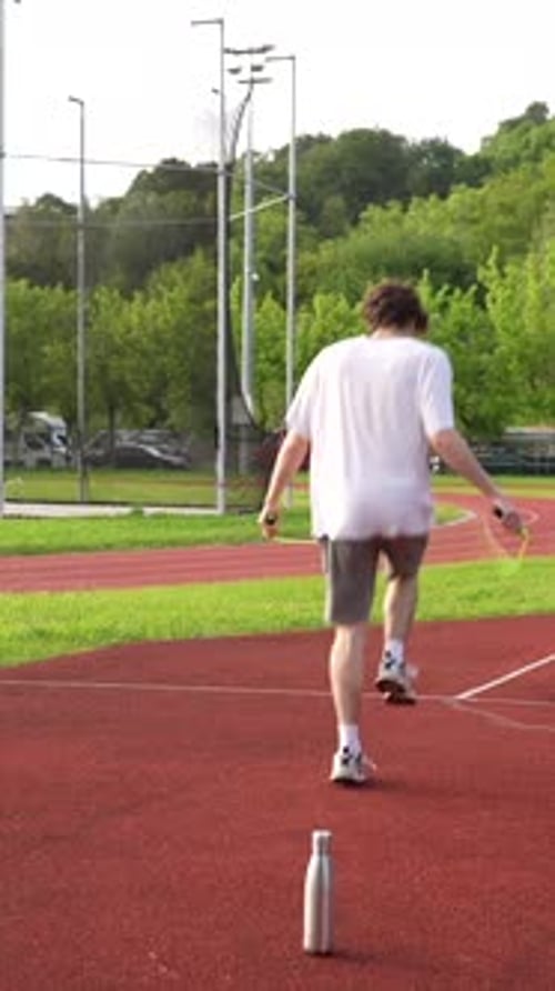 Young Man Skipping Rope Outdoors for Fitness