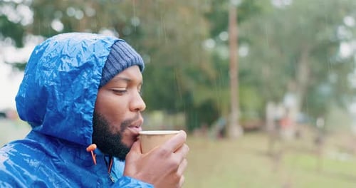 Person Drinks in the Rain Outdoors