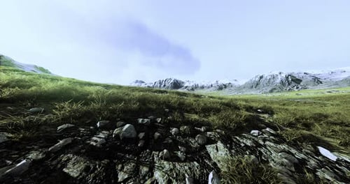 Vast Mountain Landscape with Rocky Terrain and Gentle Grass Under a Cloudy Sky