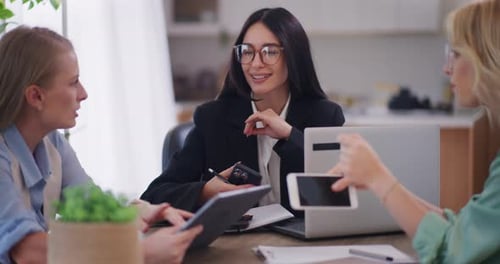 Women Collaborating in Modern Office Setting