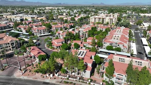 Gated apartment community in Scottsdale, Arizona. Aerial view of terracotta roofed buildings among p