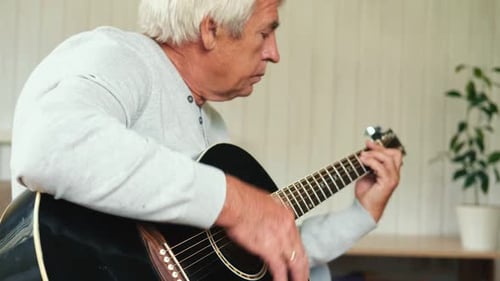 Senior Man Playing Acoustic Guitar Close Up
