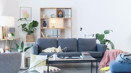 Time lapse of a woman cleaning her home. Young female doing routine chores while tidying the lounge
