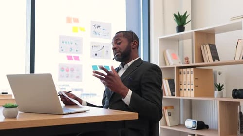 African Entrepreneur Using Laptop for Video Call at Office